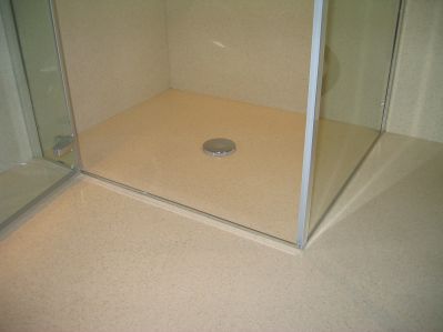 shower cubicle in corner of wet room