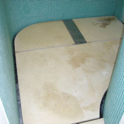 Stained limestone wet room floor