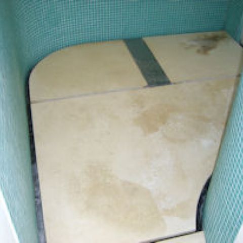 stained limestone wet room floor